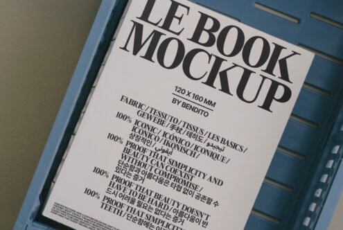 Open book mockup on slate blue tray with cream cover featuring large LB design