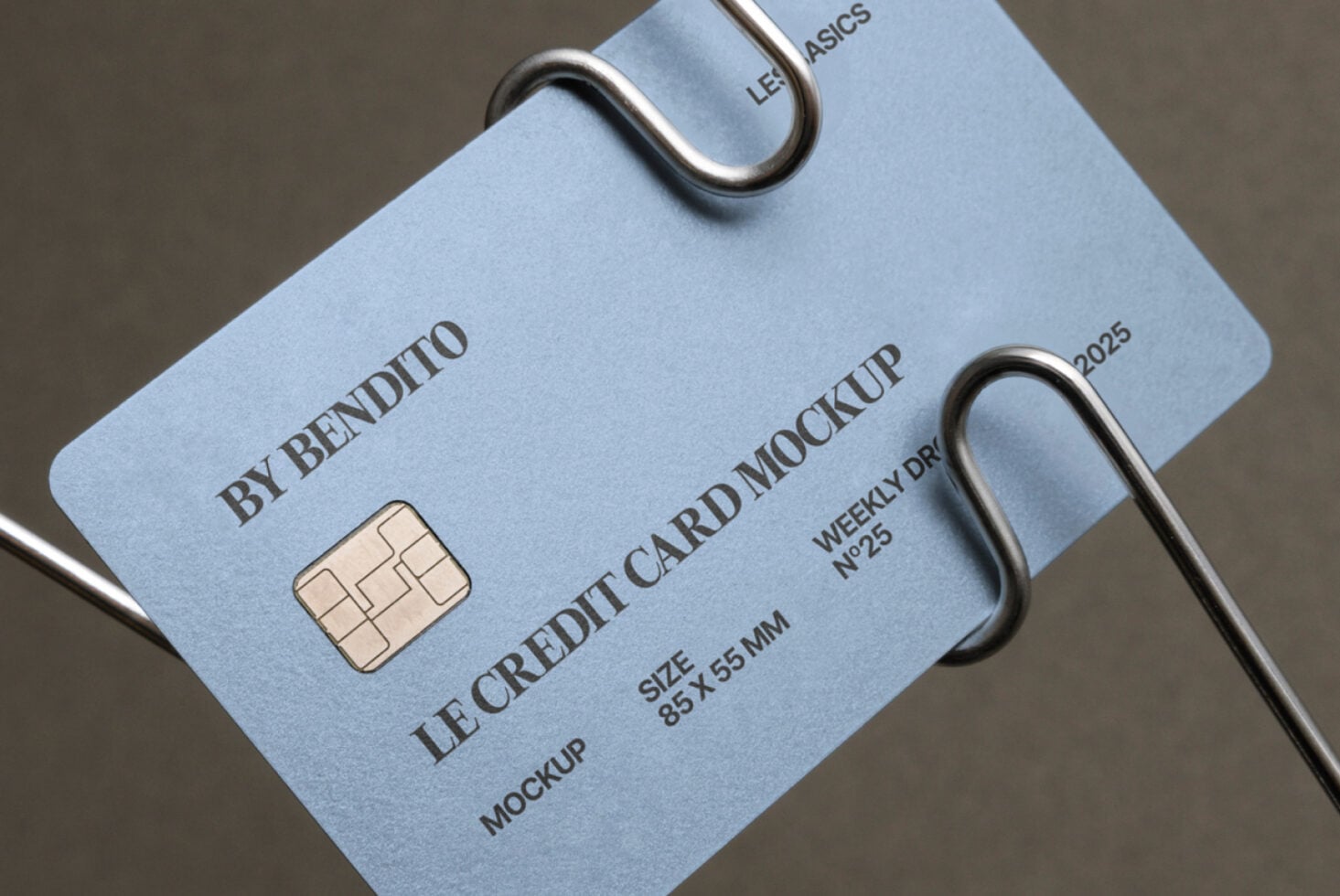 Light blue card mockup hanging from metal loops with visible chip imprint