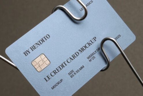 Light blue card mockup hanging from metal loops with visible chip imprint