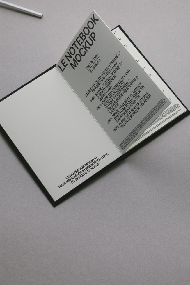 Cream-colored open notebook mockup displaying blank page with visible binding