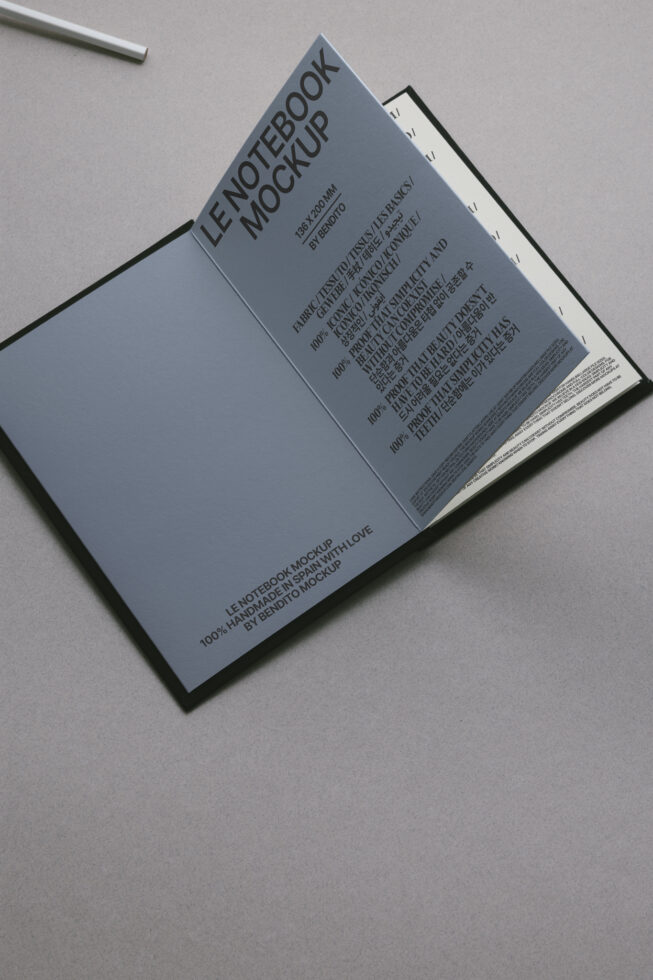 Open notebook mockup with blue cover, showing interior pages with multilingual text