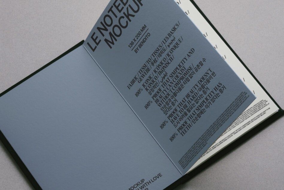 Blue open notebook mockup from above with dense multilingual typography visible