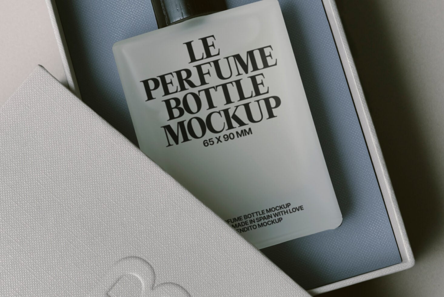 Close-up of luxury perfume bottle mockup in white box with blue tissue