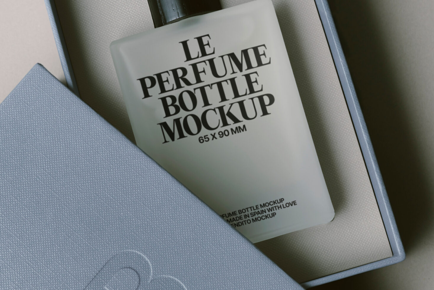 Overhead shot of fragrance bottle mockup nestled in luxury gift box packaging