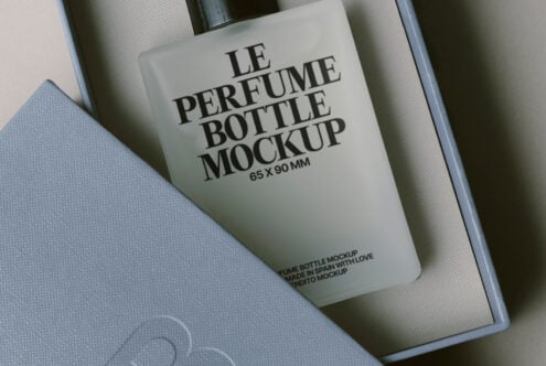 Overhead shot of fragrance bottle mockup nestled in luxury gift box packaging