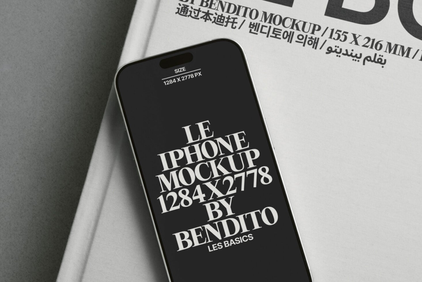 White book page with iPhone mockup displaying dark screen