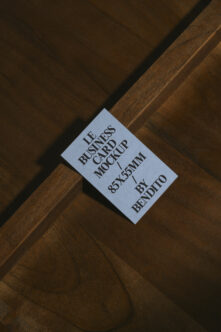 Business card mockup on wood surface showing text layout clearly visible