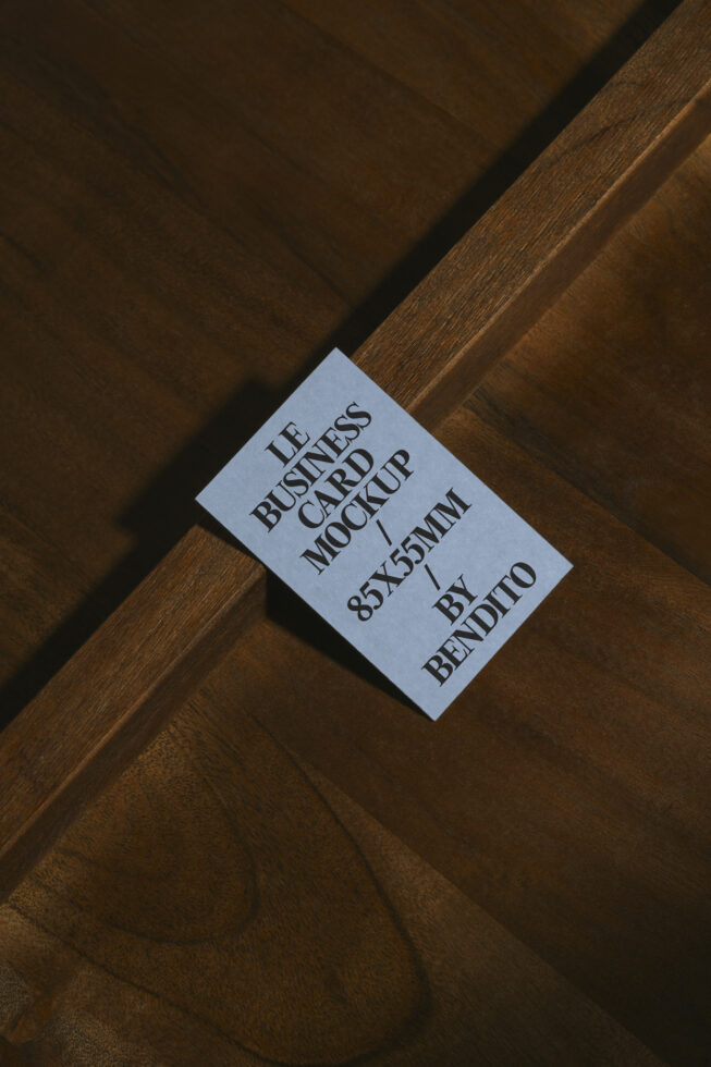 Business card mockup on wood surface showing text layout clearly visible