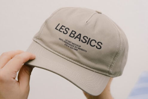 Beige cap in someone's hand displaying Les Basics logo clearly visible