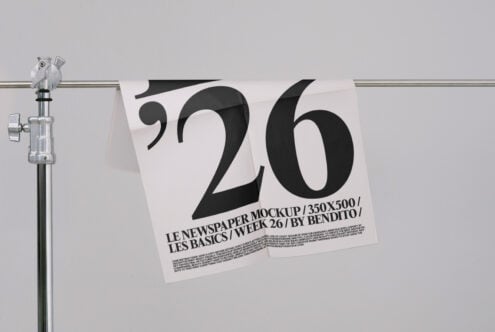 White newspaper mockup on rod displaying oversized '26' with small text below