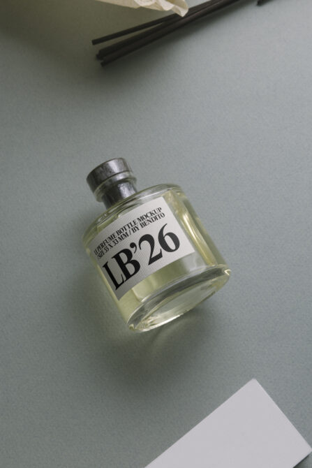 Amber perfume bottle with blue label mockup resting on table