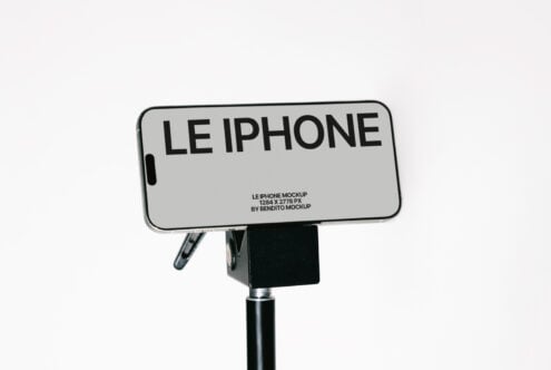 Light gray iPhone on mounted display stand against white