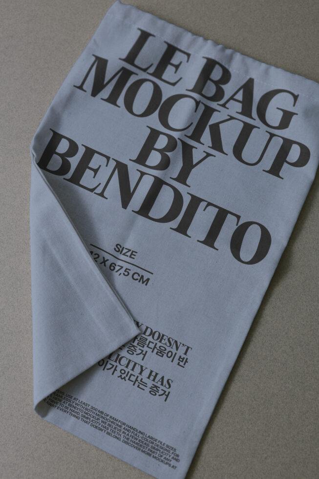 Lavender fabric tote bag mockup with serif text printed on front, flat lay view
