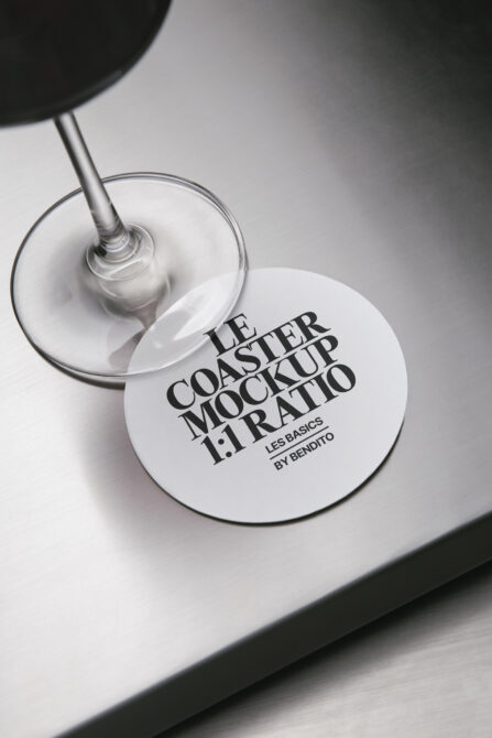 White circular coaster mockup placed on drinking glass surface