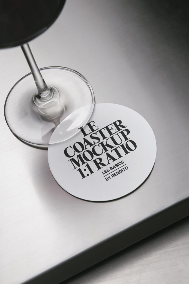 White circular coaster mockup placed on drinking glass surface