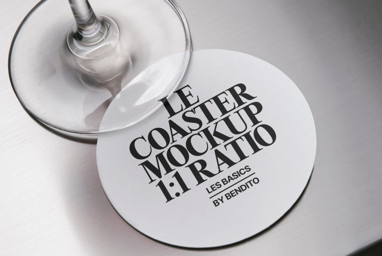 White coaster mockup with black serif typography, wine glass overhead shot