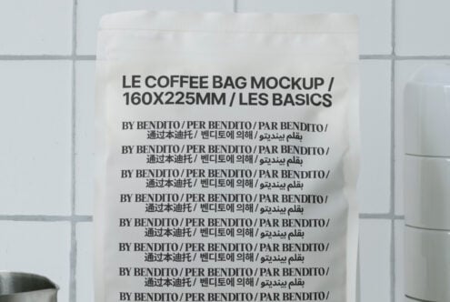 Cream colored coffee pouch on tiled surface with dark grout lines