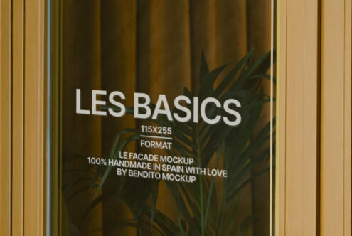 Wide storefront window with Les Basics signage, plant shadows, gold framing, olive drapes