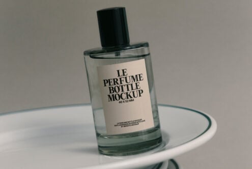 Perfume bottle mockup cream label version on layered white plates