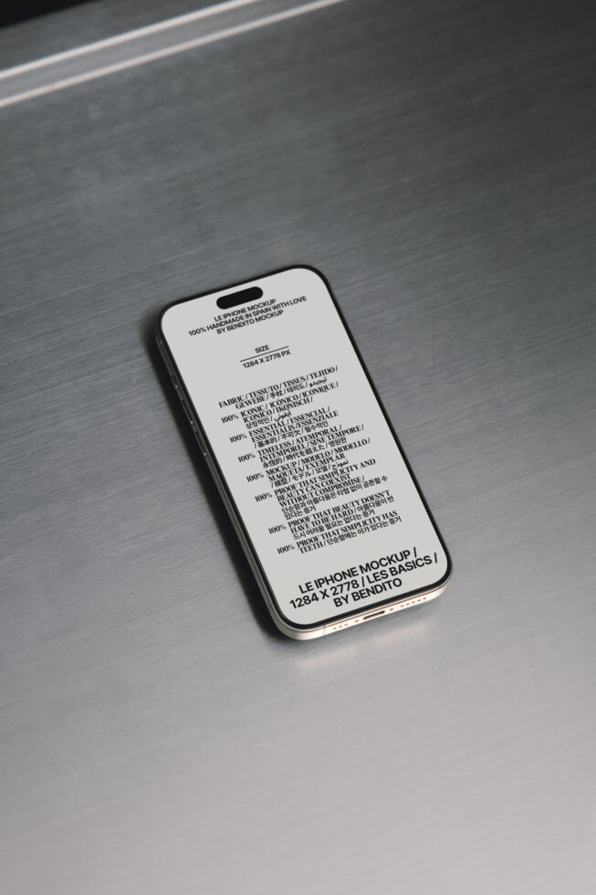 iPhone mockup with cream screen showing multilingual text on brushed metal surface