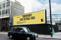 Large outdoor billboard mockup with yellow background on street