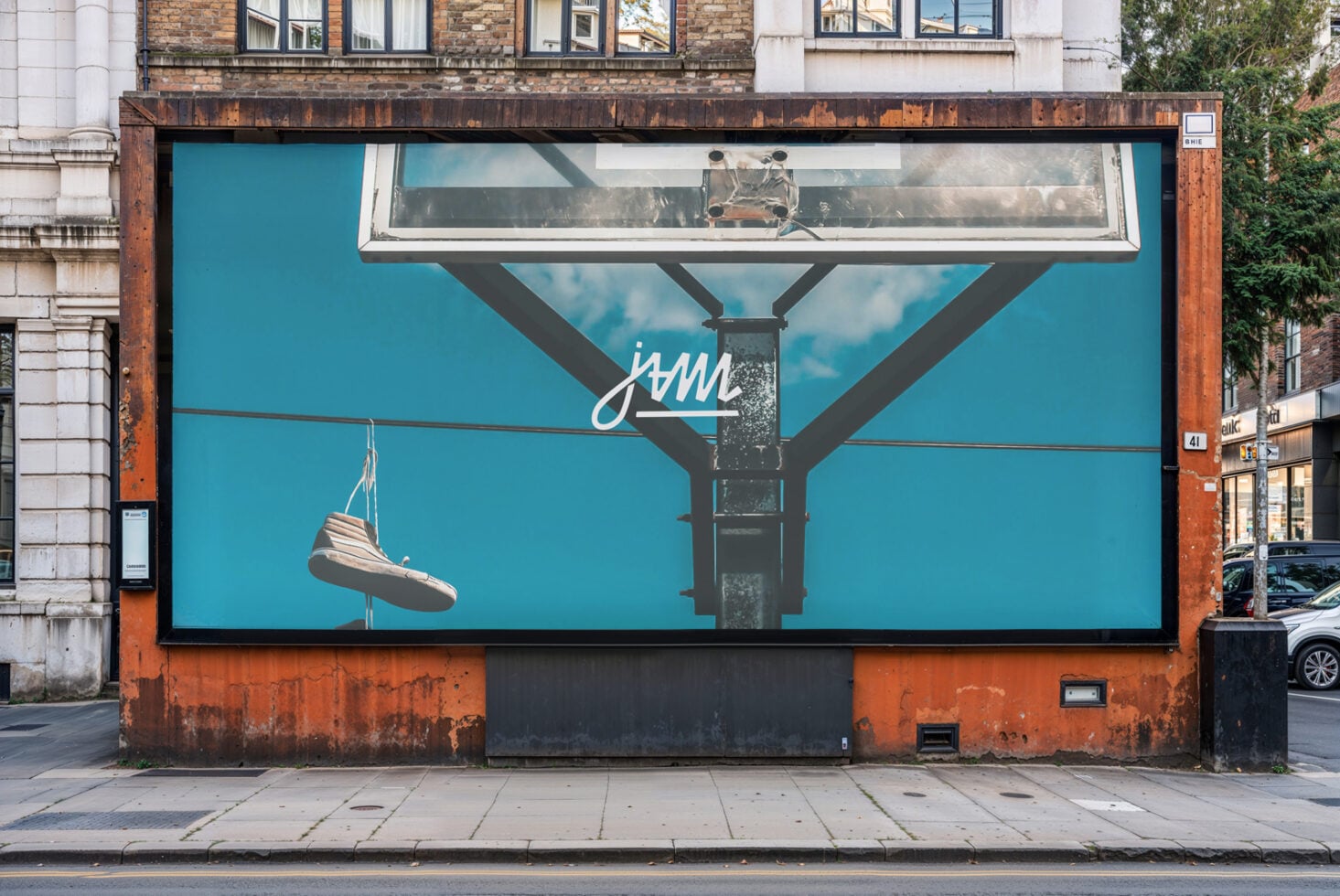 Street billboard mockup with turquoise background showing hanging shoe graphic