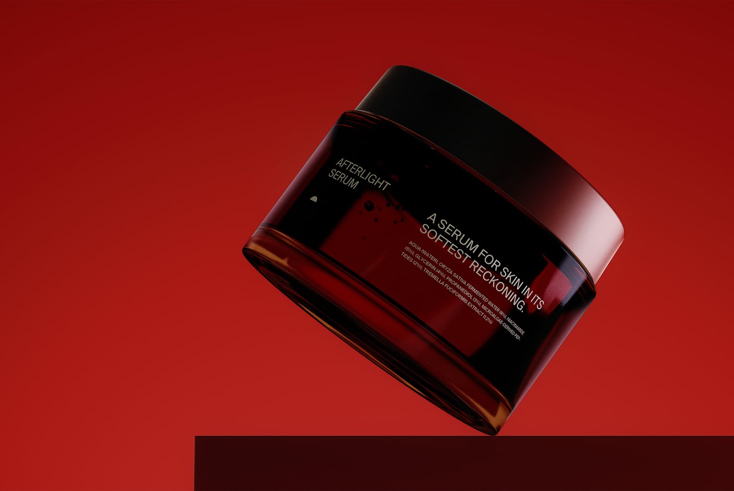 Angled view of burgundy serum bottle with metallic cap on red surface