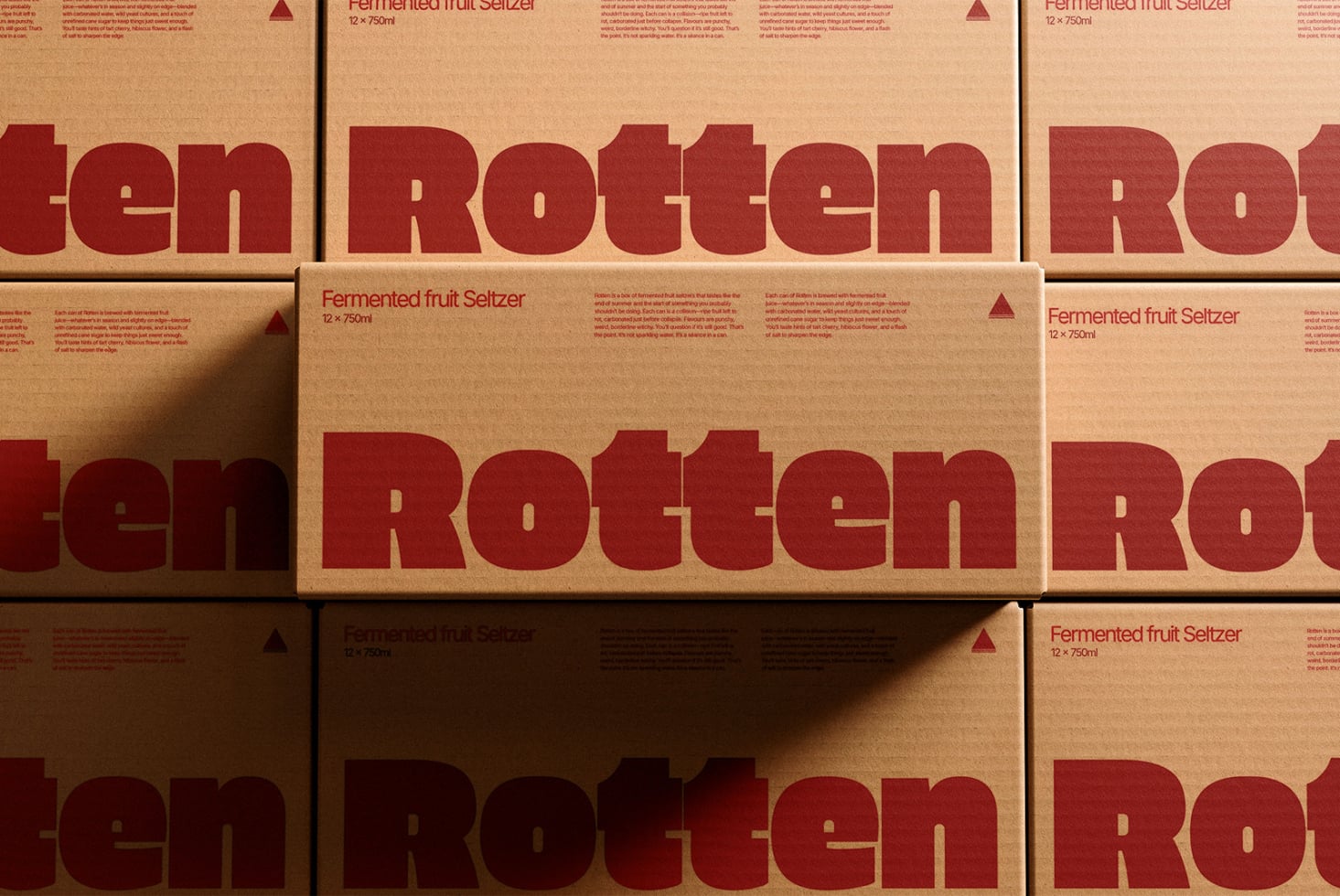 Kraft paper boxes stacked showing dark red rotten typography, beverage packaging