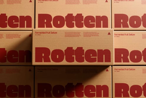 Kraft paper boxes stacked showing dark red rotten typography, beverage packaging