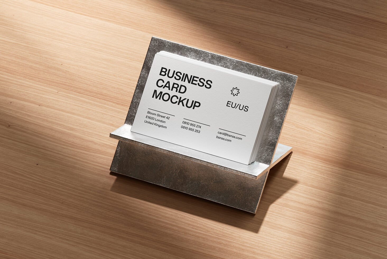 Stack of white business cards in a charcoal metal holder on wood