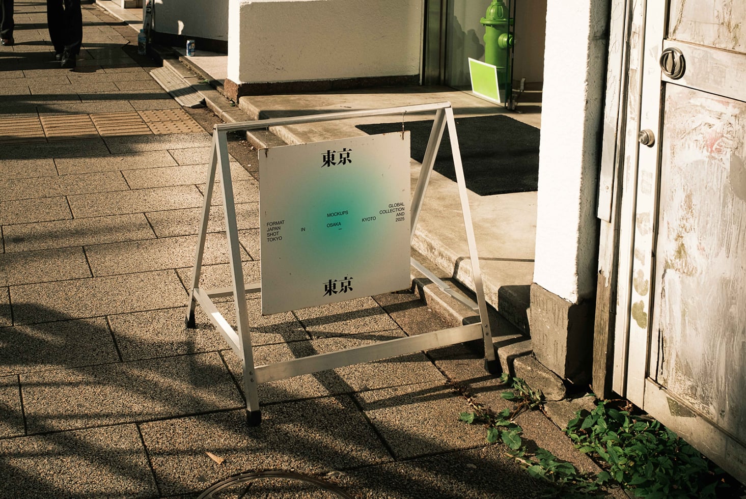 A-frame sign with gradient design on outdoor pavement in daylight
