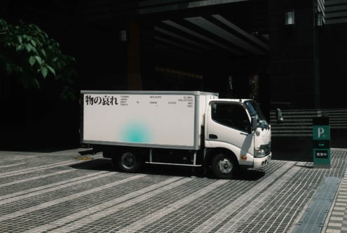 White delivery truck with light blue gradient on billboard side