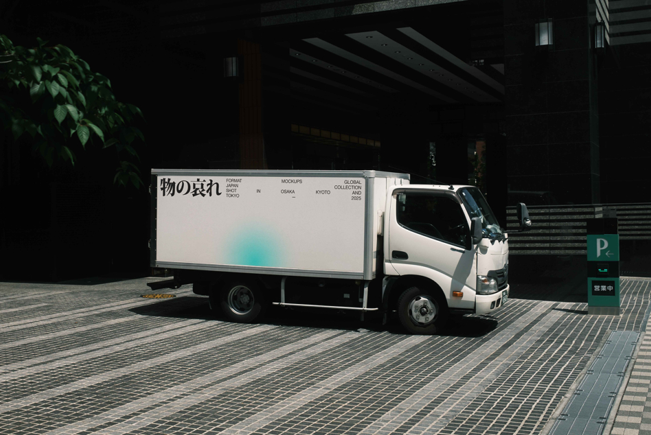 White delivery truck with light blue gradient on billboard side