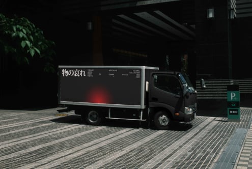 Small truck with dark billboard featuring red gradient accent