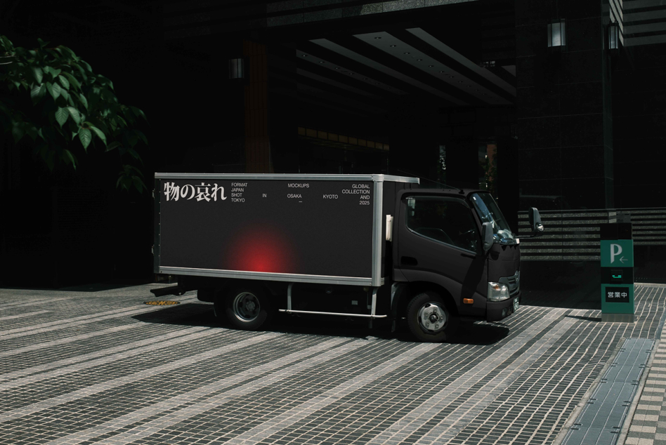 Small truck with dark billboard featuring red gradient accent