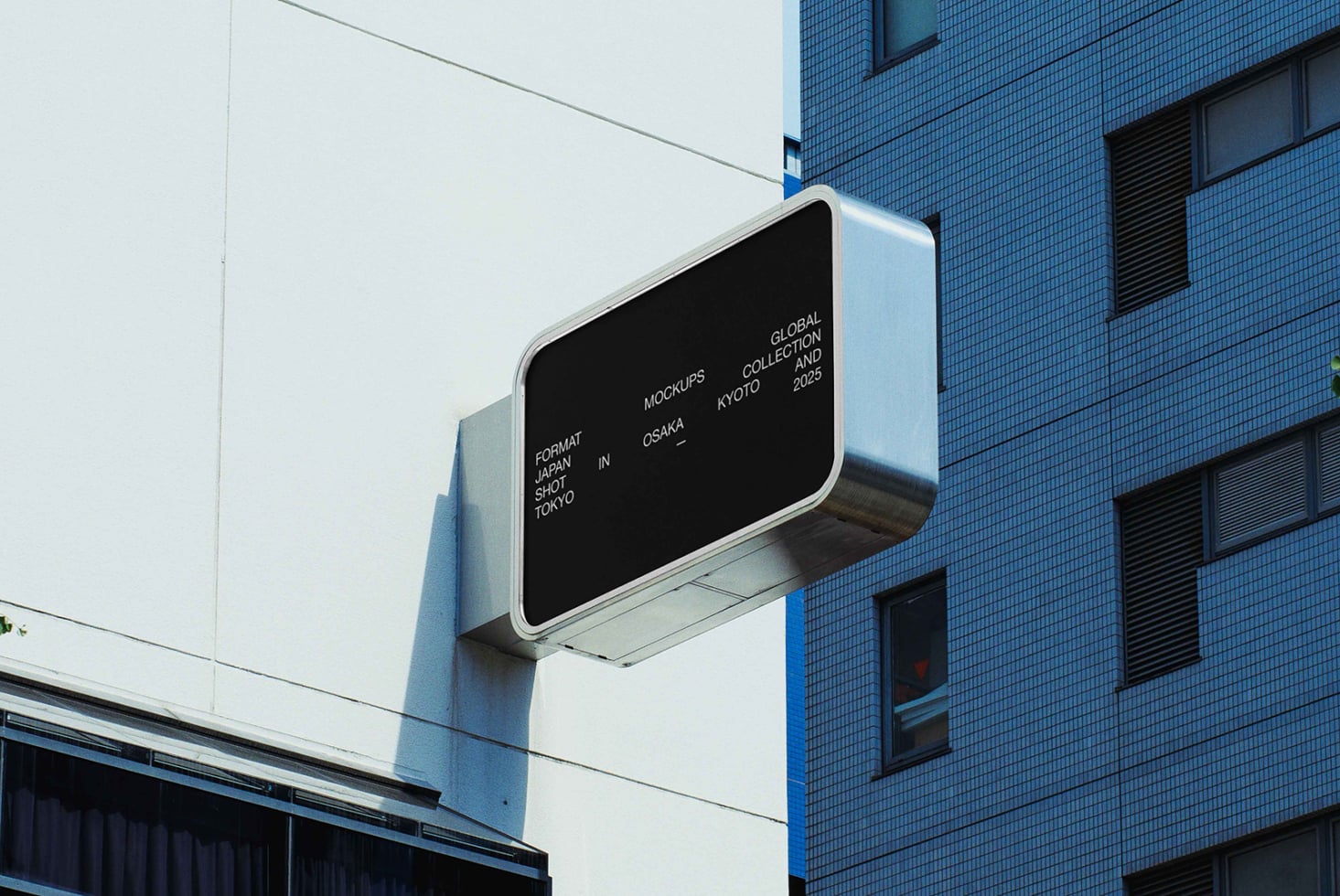 Dark street sign mockup on blue tiled building in urban setting