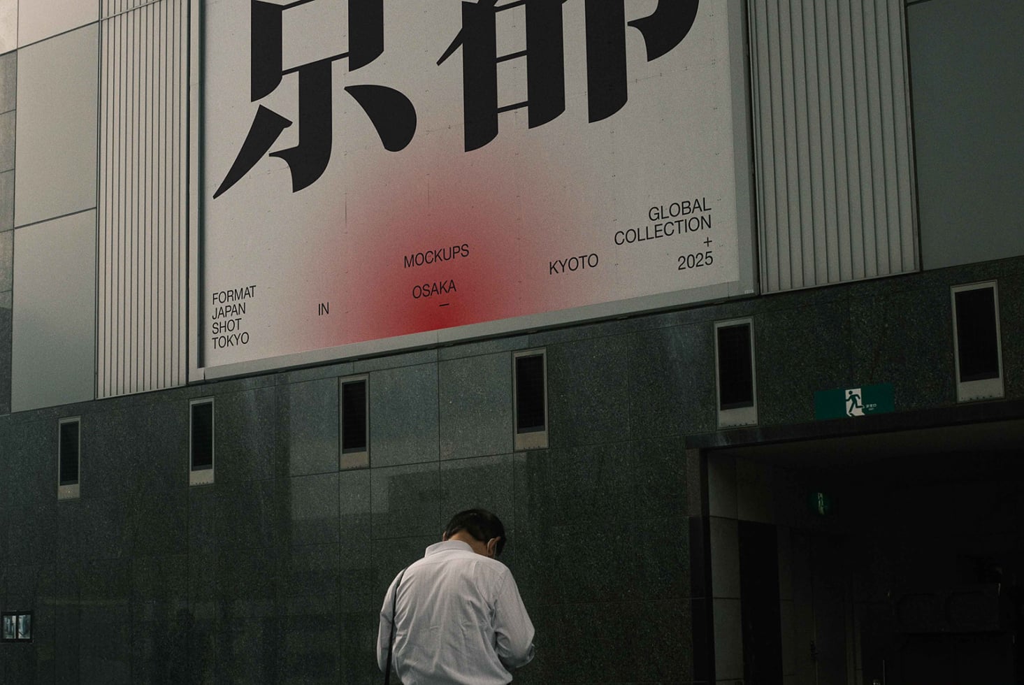 Building billboard showing Japanese kanji with red gradient, figure viewing from street level