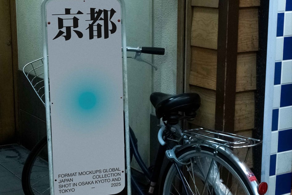 Illuminated standing sign with Japanese text mounted on street level