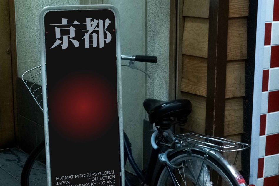 Dark red-lit standee sign with Japanese characters beside fixed bike