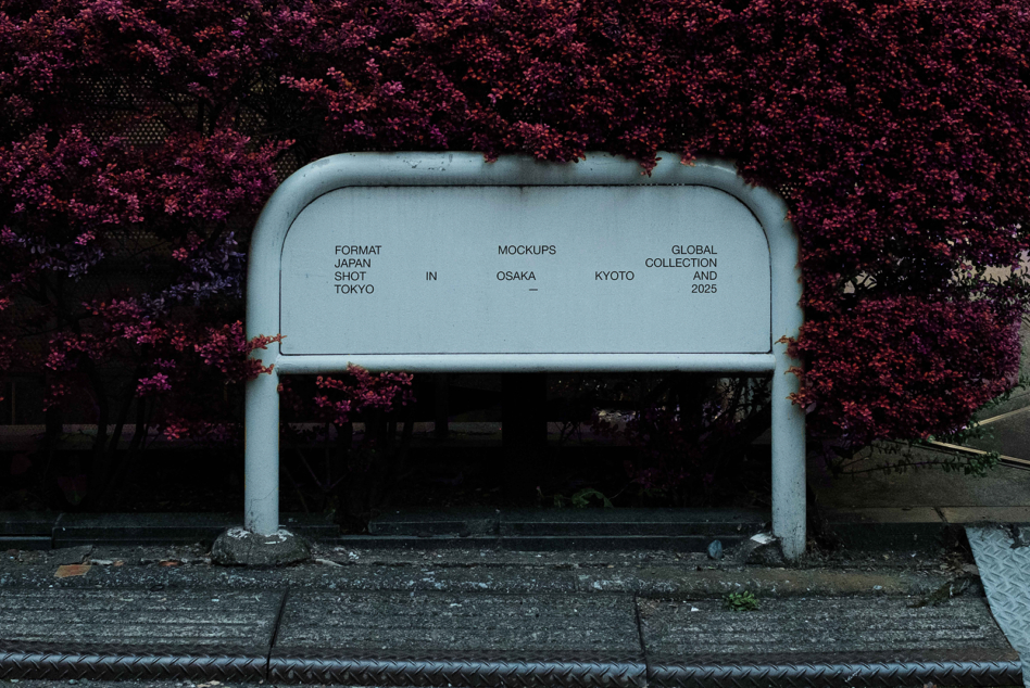 Metal bus shelter with white interior against vibrant magenta flowering vine
