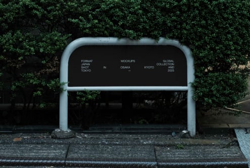 Metal bus shelter with black interior against bright green ivy coverage