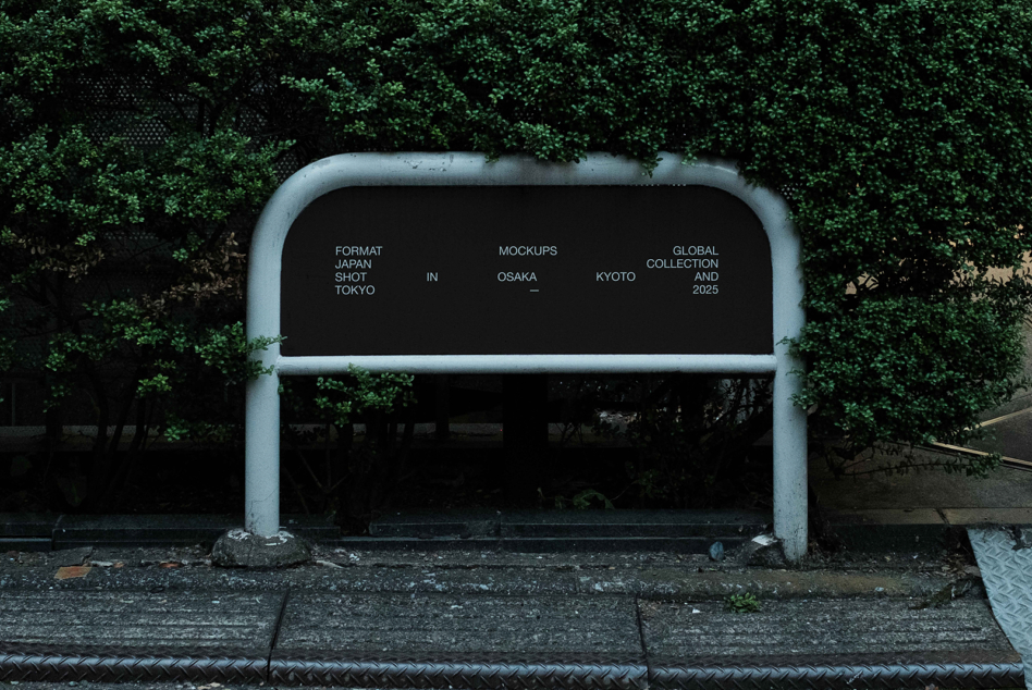 Metal bus shelter with black interior against bright green ivy coverage
