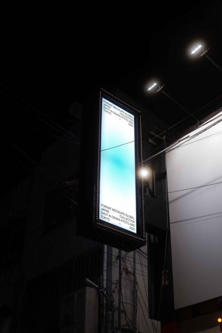 Vertical lit billboard at night with cyan gradient design