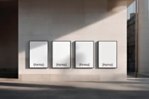 Four blank white frames hanging on minimalist gallery wall mockup