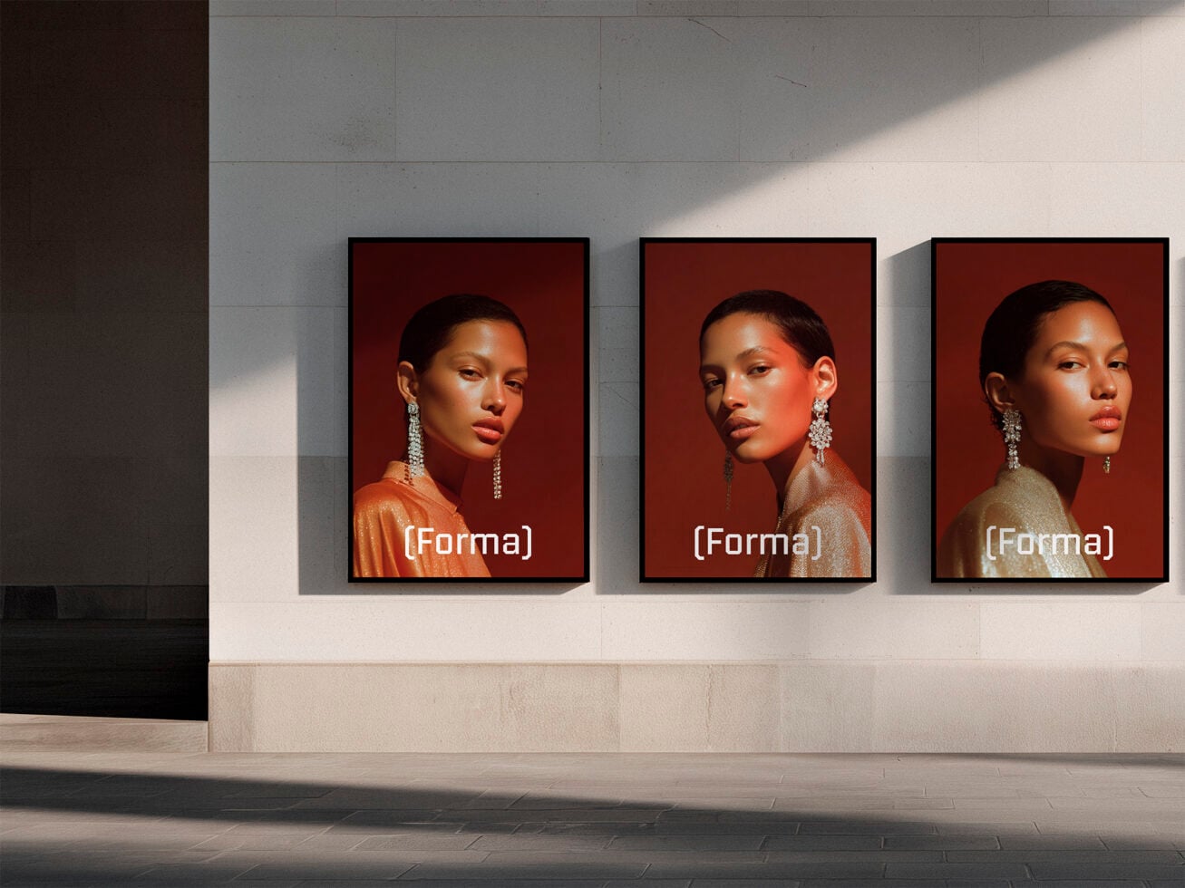 Three framed portrait photos on gallery wall with warm burgundy backgrounds
