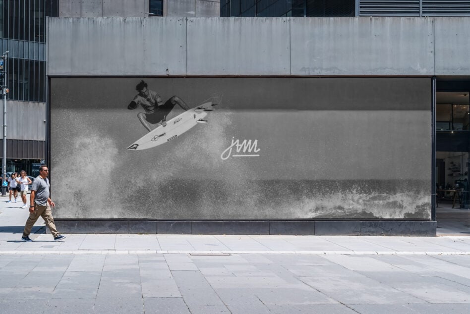 Large outdoor billboard mockup showing surfer riding wave in black white