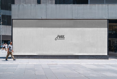Blank outdoor billboard mockup on urban street with concrete facade