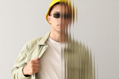 Portrait of person with yellow beanie showing half face blur effect