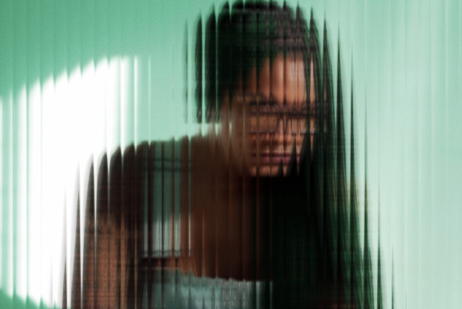 Woman with long dark hair behind green vertical line distortion effect