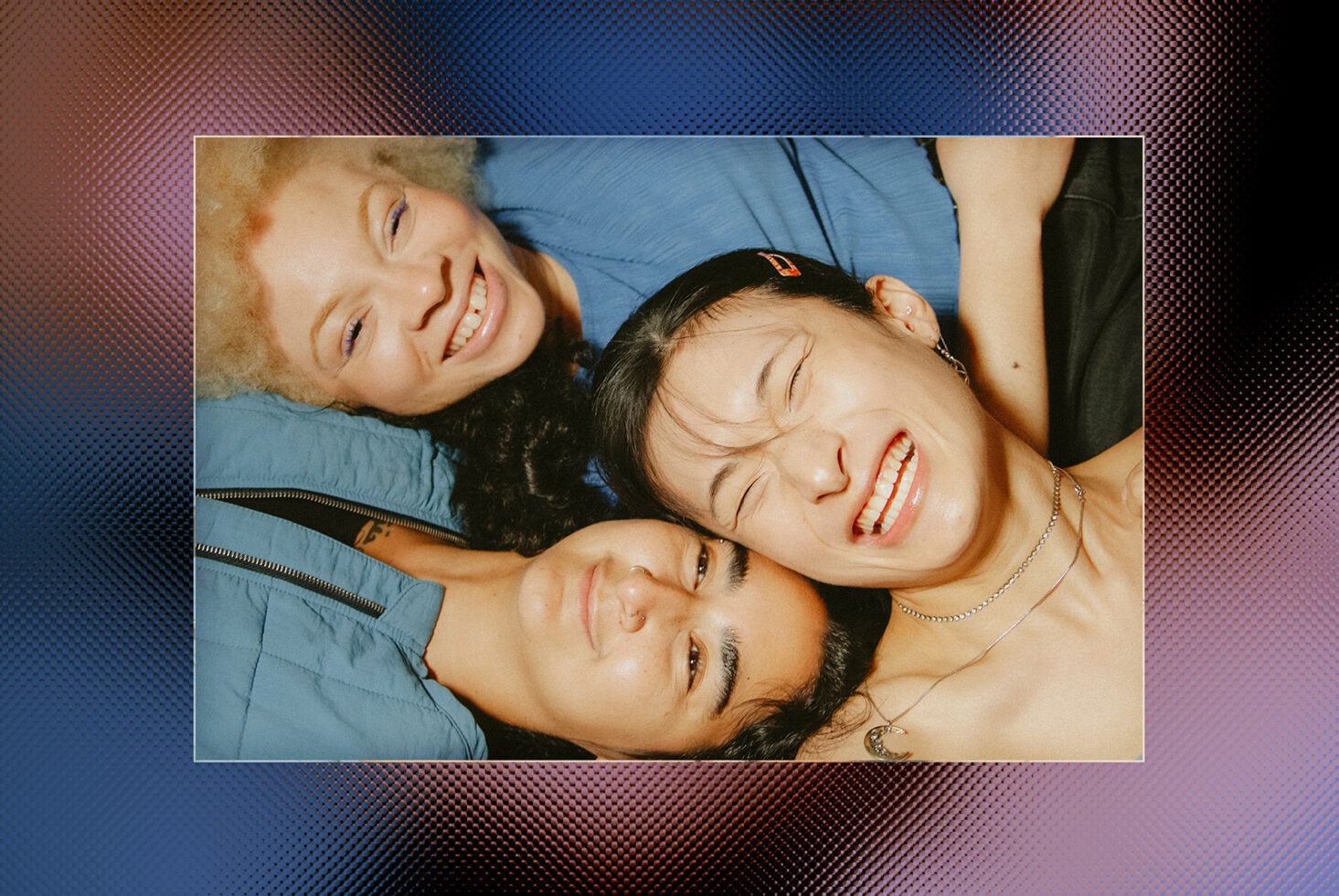 Three smiling people overhead shot with colorful gradient mesh border